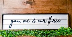 a wooden sign that says you, me and our three