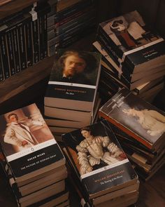 a pile of books sitting on top of a wooden table