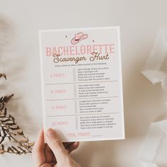 someone holding up a bachelor scavenger hunt printable for the bachelors to do