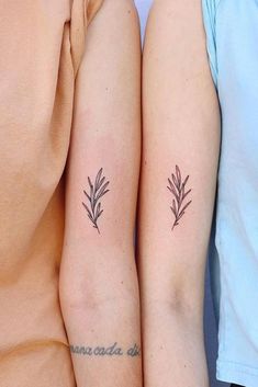 two people with matching tattoos on their arms