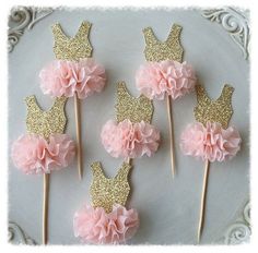 pink and gold cupcake toppers on a plate