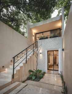 a modern house with stairs leading up to the front door