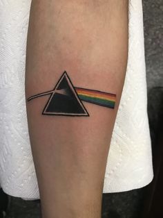 a dark side of the moon tattoo with a rainbow on it's arm and a pink floyd triangle