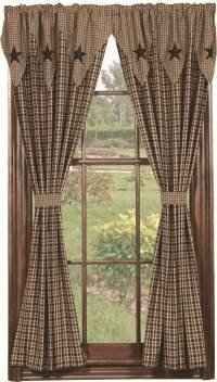 an open window with curtains and stars on the curtain valance, in front of a green field