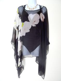 "Black Silk Poncho - Silk Cover Up- Black and White - Orchids - Sheer Floral Caftan - Plus Clothing Wear it long, Tie it on the side. Tie it in the back. BELT IT! Enjoy the many ways you can wear your silk poncho. This is a continuous pattern. Each wearable varies slightly as the pattern may adjust for different placements. Color - Black, White Material - Sheer Silk Georgette, Gauzy texture SIZE - One Size, Plus - Measures approx. -Front & Back - 24\" long from neck to lower hem on both side Summer Evening Floral Print Kaftan, Elegant Black Kaftan With Floral Print, Fitted Kaftan For Summer Evening, Fitted Kaftan For Evening In Summer, Fitted Kaftan For Evening And Summer, Black Spring Kaftan For Evening Wear, Black Spring Evening Kaftan, Chic Fitted Summer Kaftan, Silk Poncho