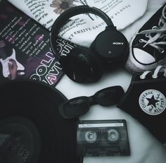 a pair of headphones sitting on top of a table next to an old record