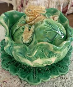 a green bowl sitting on top of a table