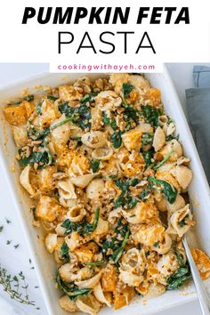 pumpkin feta pasta with spinach and cheese in a white casserole dish