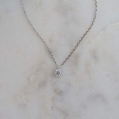 This delicate necklace featuring a tiny bezel pendant is a must-have staple piece! It is great for layering, but also adds a sweet minimalist touch to any look/outfit. Dress it up or down, you just can't go wrong with this piece! Made of 925 Sterling Silver We use a THICK, DURABLE 14k Gold or Rhodium plating for a piece that will last you years to come! Available in 16" + 3" Extension Chain Nickel-free & Hypoallergenic Everyday Solitaire Pendant Necklace With Delicate Chain, Everyday Minimalist Solitaire Necklace With Bezel Setting, Dainty Solitaire Pendant Necklace For Everyday, Minimalist Solitaire Pendant Necklace With Delicate Chain, Delicate Solitaire Necklace With Clavicle Chain For Everyday, Dainty Round Solitaire Necklace For Everyday, Delicate Silver Solitaire Necklace For Everyday, Everyday Delicate Silver Solitaire Necklace, Dainty Solitaire Necklace With Clavicle Chain And Round Pendant