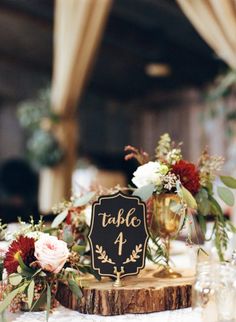 there is a table with flowers on it and a sign that says table 4 in the center