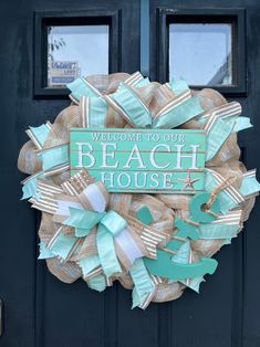 a welcome to our beach house wreath on the front door