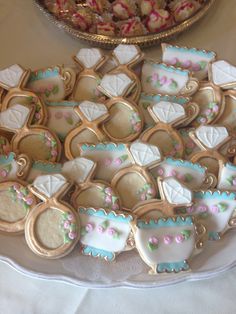 a plate full of decorated cookies on a table next to a platter of candy