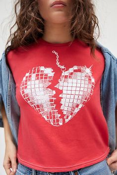 Shining just for you in this slim & cropped tee featuring a broken heart disco ball graphic across the front. Features a crew neckline and short sleeves, washed soft for a vintage look & feel. Only at Urban Outfitters. Features Broken heart disco ball graphic slim tee Fitted graphic tee Washed soft for a vintage look and feel Crew neckline with short sleeves Broken heart disco ball graphic across the chest Slim fit Cropped length Easy pull-over style UO exclusive Content + Care 100% Cotton Machi Red Graphic Tee Cropped T-shirt, Grunge Short Sleeve Top With Heart Graphic, Disco Style Cotton Short Sleeve Tops, Disco Style Cotton Top With Short Sleeves, Grunge Crew Neck Top With Heart Graphic, Disco Style Graphic Print Short Sleeve Top, Urban Outfitters Grunge Short Sleeve Tops, Disco Ball Shirt, Heart Disco Ball