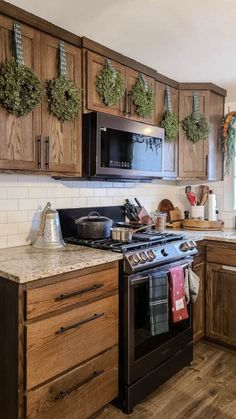 a kitchen with wooden cabinets and black appliances