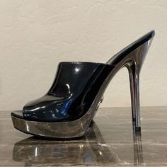 These Stunning Stiletto Heels Feature A Wide Black Patent Leather Upper With A Peep Toe Design. Shiny Silver Tone Platform And Stiletto Heel Are Absolutely Gleaming! Some Superficial Scuffing/Creasing These Are In Very Good/Excellent Condition! Brand New Heel Caps! Soles Have Minimal Wear. Simply Stunning. You’ll Command The Attention Of The Room. Certificate Of Authenticity Included, As Are Dust Bags. Women’s Size 9 Fits Size 8.5-9 Approx. 5.5” Heel Including 1.25” Front Platform K3 Modern Silver Patent Leather Heels, Luxury Open Toe Heels With Metal Feet, Luxury Metallic Patent Leather Heels, Sleek Metallic Patent Leather Heels, Sleek Silver Patent Leather Heels, Sleek Metallic Open Heel Shoes, Silver Patent Leather Platform Heels, Silver Patent Leather Heels For Formal Occasions, Luxury Heels With Metal Feet For Night Out