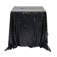 a black table cloth with silver sequins on it