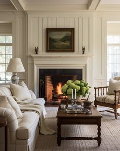 a living room filled with furniture and a fire place next to a painting on the wall