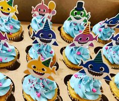 cupcakes with blue frosting and shark decorations