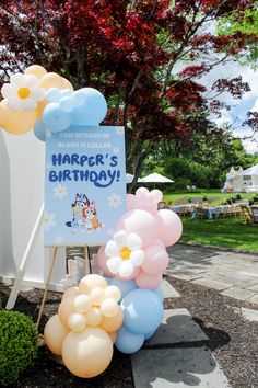 balloons are arranged in front of a sign that says harper's birthday