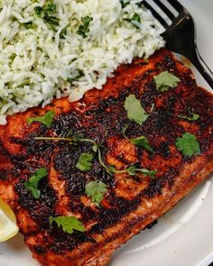 the salmon is cooked and ready to be served on the plate with rice as garnish