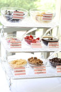 three tiered trays filled with different types of desserts on top of a table