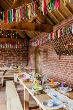 the tables are set with colorful streamers hanging from the ceiling and plates on them