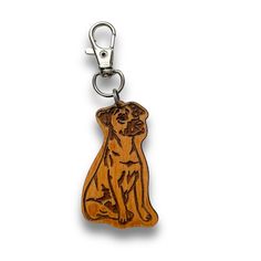 a wooden key chain with a dog on it