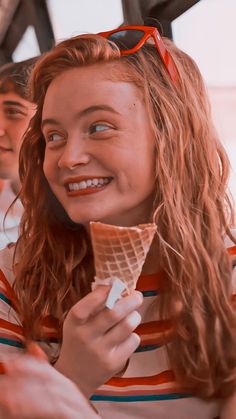 a young woman eating an ice cream cone