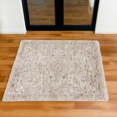 a rug on the floor in front of a door