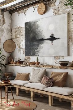 a living room filled with lots of furniture next to a large painting on the wall