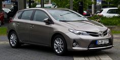 a silver car is parked on the street