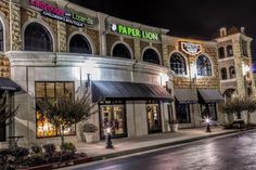 an empty street in front of a store at night