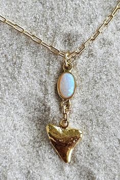 Gorgeous gold plated shark tooth kissed with an opal pendant fit for a Mermaid! Dainty and beautiful! Great gift for surfers, beach girls to scuba and freedivers to express their love Ocean creatures! Such a flattering beach style to mix and match with other Kikita Jewelry pieces.  *18k gold over silver shark tooth 11mm x10mm  *Opal stone pendant 14k plated 5.5mm x8mm *18k gold-plated paperclip style necklace- length: 16 Inches + 2inch extension *Lobster clasp closure   All Products are inspected for Quality 🤍To extend the lifetime of your item you must keep away from natural oils, sunscreen, and perfume will naturally tarnish your jewelry over time🤍 Let me know if you have any questions!  ♡Shipped from Sunny Florida!♡ Customer service is my priority if there is problem with the order me Tropical Necklace, Silver Shark, Gifts For Surfers, Preppy Jewelry, Ocean Lover, Shark Teeth, Summer Necklace, Opal Pendants, Dream Jewelry