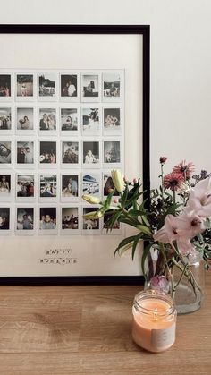 a vase filled with flowers sitting next to a candle on top of a wooden table