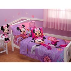 a child's bedroom with minnie mouse bedding