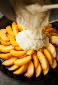 a bowl filled with sliced peaches and pita bread