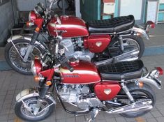 two red motorcycles parked next to each other