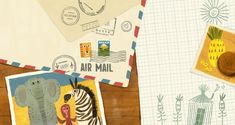 an air mail envelope with stamps and pictures of animals on it next to a postcard