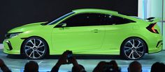 a bright green car is on display at an auto show while people are taking pictures