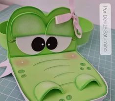 a green frog shaped box sitting on top of a table