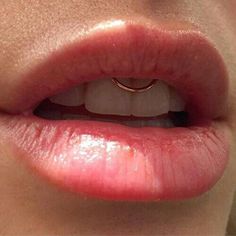 a woman's lips with a wedding ring on her lip