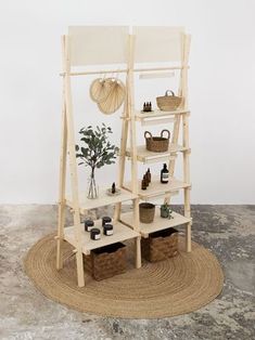 a wooden shelf sitting on top of a rug next to a potted plant