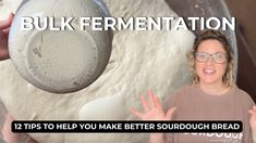 a woman holding a spoon in front of a bowl filled with doughnuts and flour