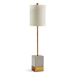 a lamp with a white shade on the top and a gold base, sitting on a white background