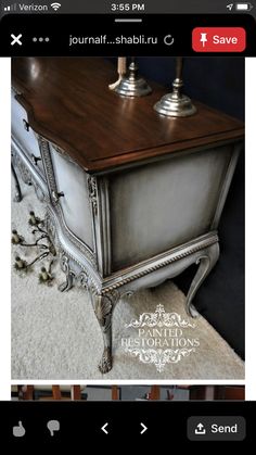 an antique dresser with two candles on top