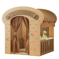 a wooden play house with an open door and curtains on the front, in beige