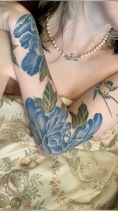 a woman with blue flowers on her arm