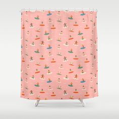 a pink shower curtain with surfers and boats on it