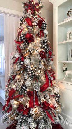 a christmas tree decorated with red, white and silver ornaments