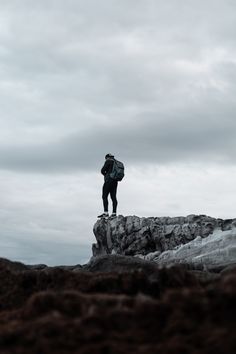 a man standing on top of a rock formation